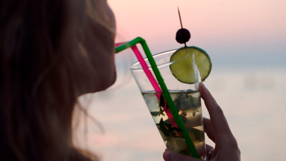 Woman Drinking Mojito With A Straw
