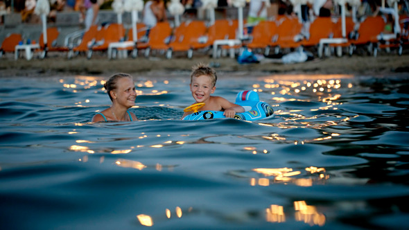 Mother And Son Swimming In The Evening