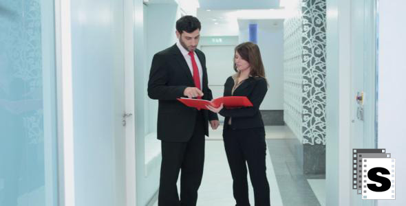 Business Couple Working In The Hallway 