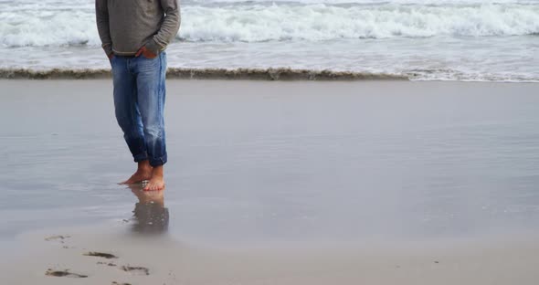 Mature man standing on the beach