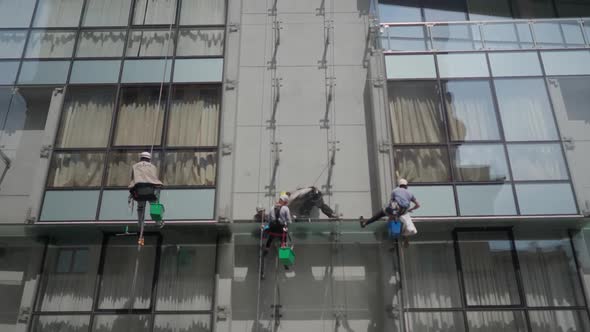 Industrial Window Cleaners at a High Height of the Glass Facade
