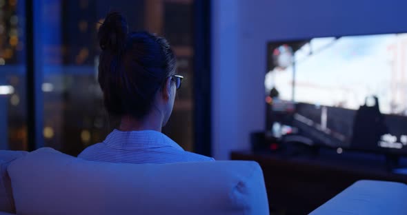 Woman play tv game at home in the evening