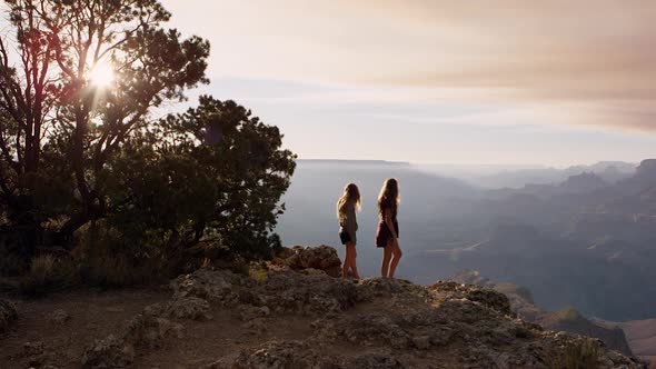 Two teenage girls looking at the Grand Canyon from the South Rim