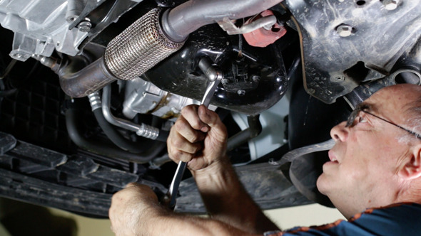 Car Repair Mechanic Removing the Oil Cap