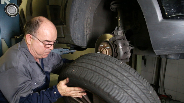 Car Repair Mechanic Changing Wheel