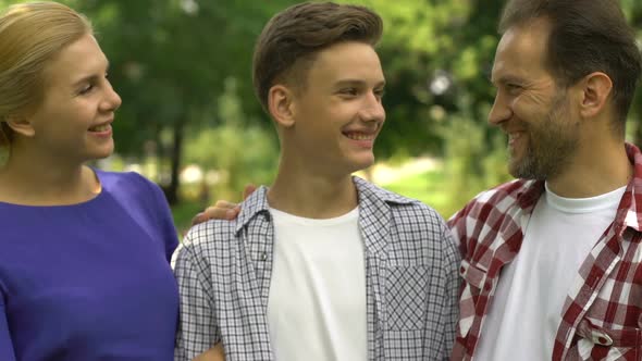 Joyful Parents and Son Smiling at Camera, Result of Successful Family Therapy