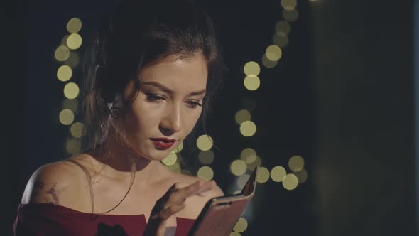 Close Up Portrait of Young Asian Girl Browsing News or Social Media Posts Alone