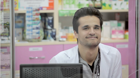 Pharmacist Smiling To A Client