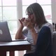 Older woman working from home on her laptop computer at dining room table - VideoHive Item for Sale