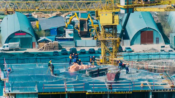 Builders in Uniforms and Hardhats Work on Modern Building
