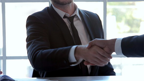 Three Businessmen Handshake