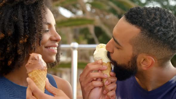 Couple eating ice cream cone at beach 4k