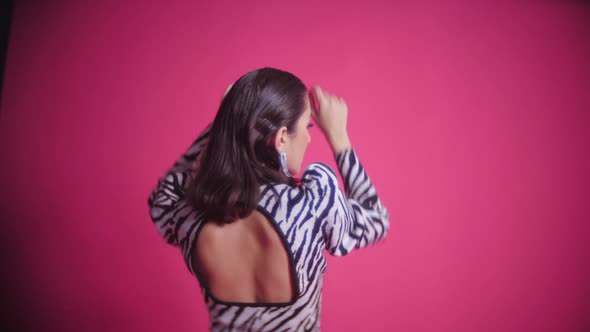 Sexy Young Fashion Model Asian Woman is Standing in a Zebra Striped Dress in the Studio