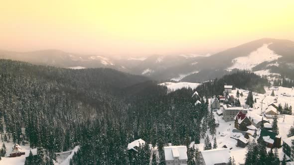 Amazing Aerial Flight Over Colorful Sunrise in the Mountains in Winter