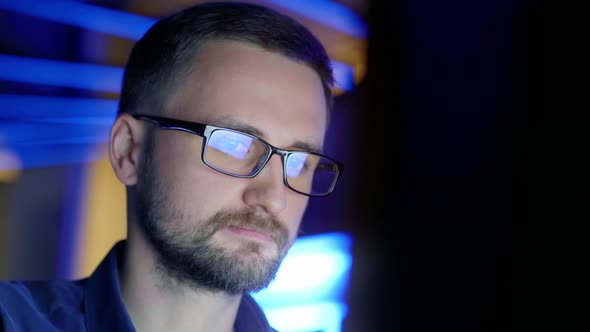 Closeup of a Concentrated Man in Glasses Who Works at a Computer