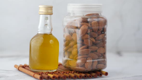 Almond Oil in Bottle on Wooden Background