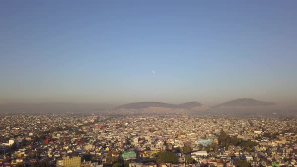 Mexico city aerial drone shot, sunrise with contamination and moon