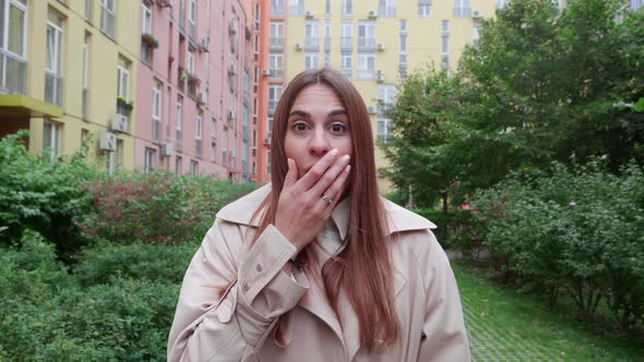 Surprise and Excited Young Woman Over Colorfull Building