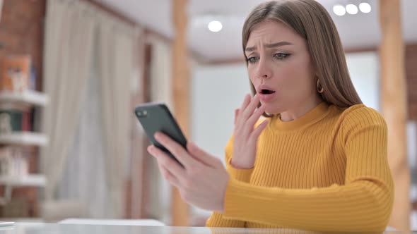 Young Woman Reacting To Failure on Smartphone 