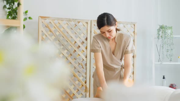 Asian young woman feeling happy and relax during back massage with oil.