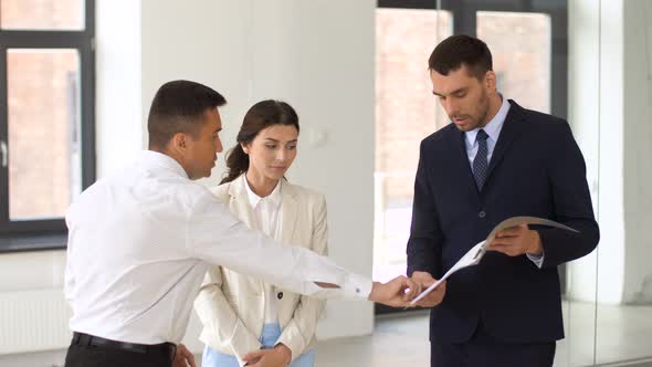 Realtor with Folder Showing Documents To Customers 5