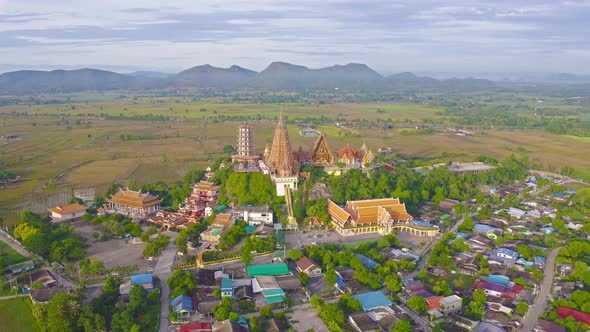 Aerial view of Big Golden Buddha Statue and pagoda in Tiger Cave Temple or Wat Tham Suea