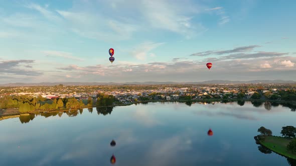 Hot air balloons taking off and heading over Hamilton City in New Zealand for Balloon festival.