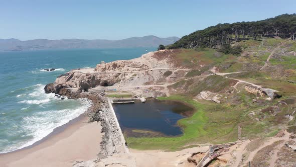 Panning aerial shot of the ruins of the Sutro Baths at Land's End in San Francisco. 4K