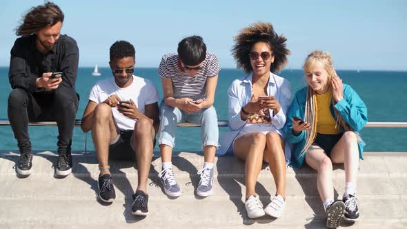 Contemporary Diverse Friends with Smartphones on Seafront