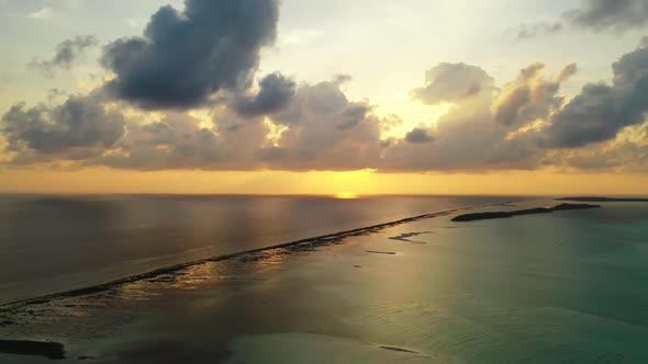 Aerial top down tourism of marine resort beach wildlife by aqua blue sea and white sandy background 