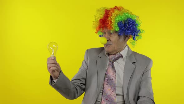 Senior Clown Businessman Freelancer Show Light Bulb. Came Up with Great Idea