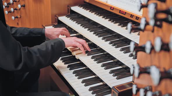 Organist Plays Music on Church Organ