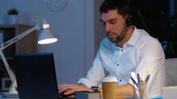 Businessman in Headset with Laptop at Night Office 44