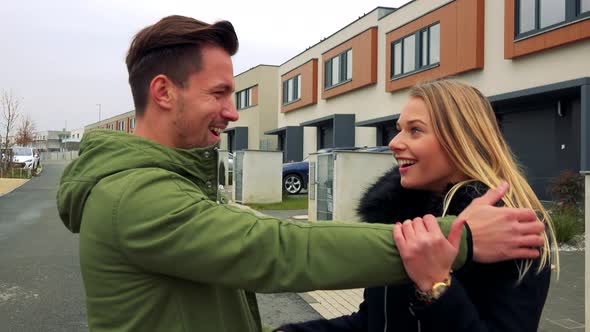 Two Young, Attractive Friends Meet on a Street