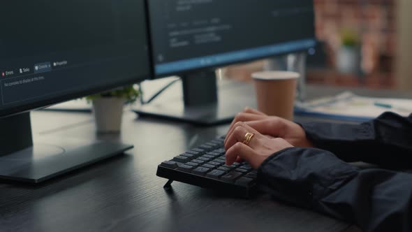 Focus on Software Developer Hands Typing Source Code on Keyboard While Looking at Computer Screen