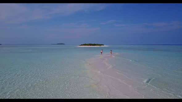 Boy and girl in love on luxury resort beach time by blue sea with white sandy background of the Mald