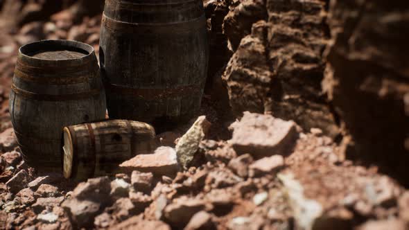 Old Wooden Vintage Wine Barrels Near Stone Wall in Canyon