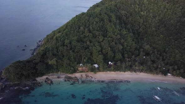 Aerial view of beautiful beach by wild jungle on island in the Philippines - camera pedestal down ti