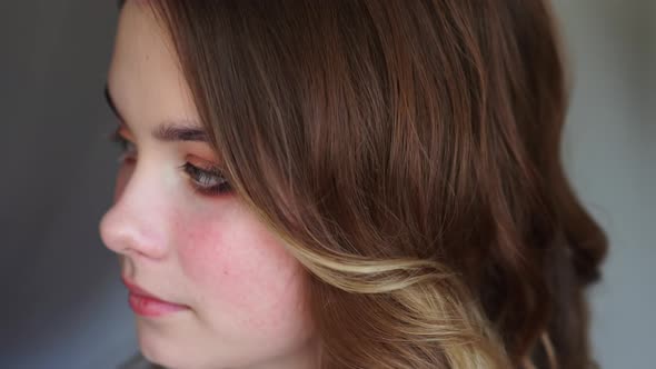 Girl Makeup Artist Paints the Eyes of a Young Girl