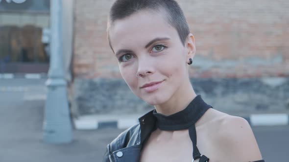 Young Attractive Woman with Short Hair Against Urban Background.