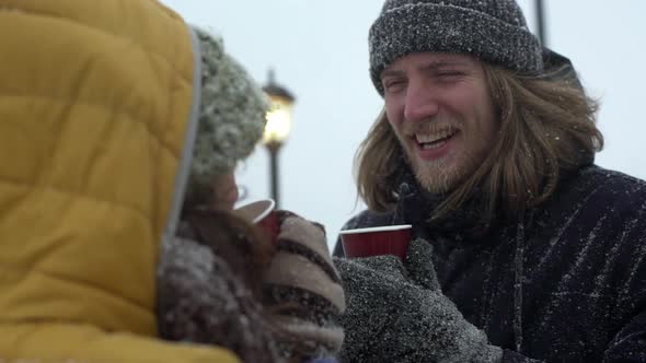 Portrait of Adorable Young People Man and Woman Drinking Tea or Coffee From Paper Cups at Seaside