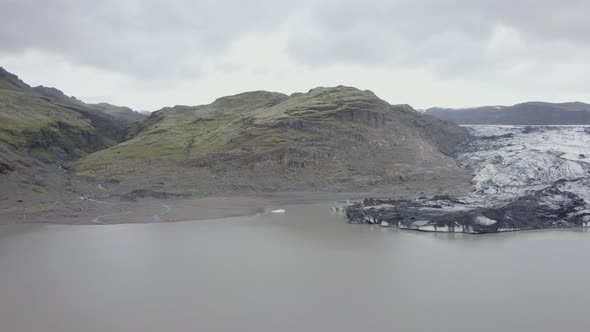 Aerial drone view over the lagoon at the Solheimajokull Glacier, in Iceland - reverse, drone shot