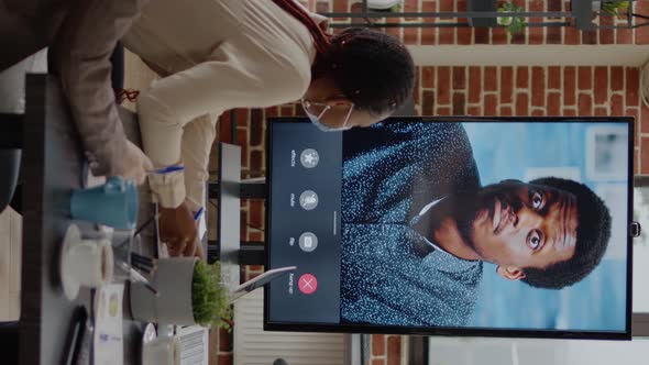 Vertical Video Workmates with Face Mask Talking on Video Conference Call to Man