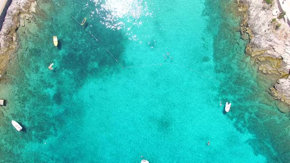 Aerial view of people swimming in turquoise bay