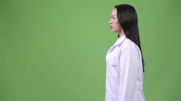 Profile View of Young Beautiful Asian Woman Doctor Wearing Protective Glasses