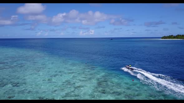 Aerial drone seascape of idyllic coast beach adventure by blue ocean with white sand background of a