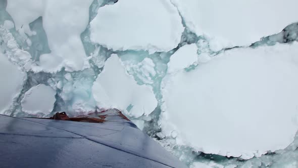 Ship Breaking Through Ice In Antarctica