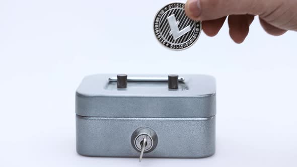 Little Saving Vault Hand Holds Silver LTC Litecoin Virtual Money