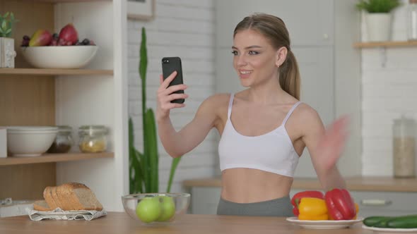 Athletic Woman Doing Video Call on Smartphone in Kitchen