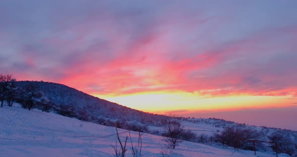 Colorful Sunset Sky Above the Snowy Mountains